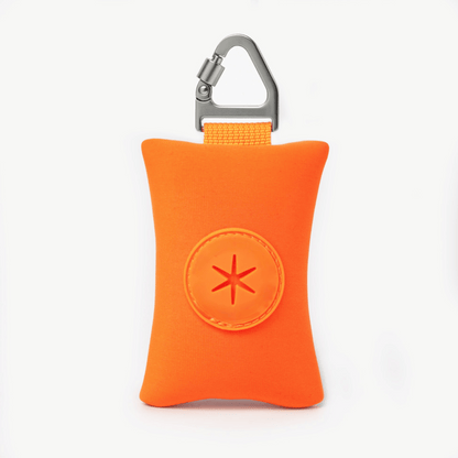 Compact orange dog poop bag holder with carabiner, ideal for clean and stress-free walks.
