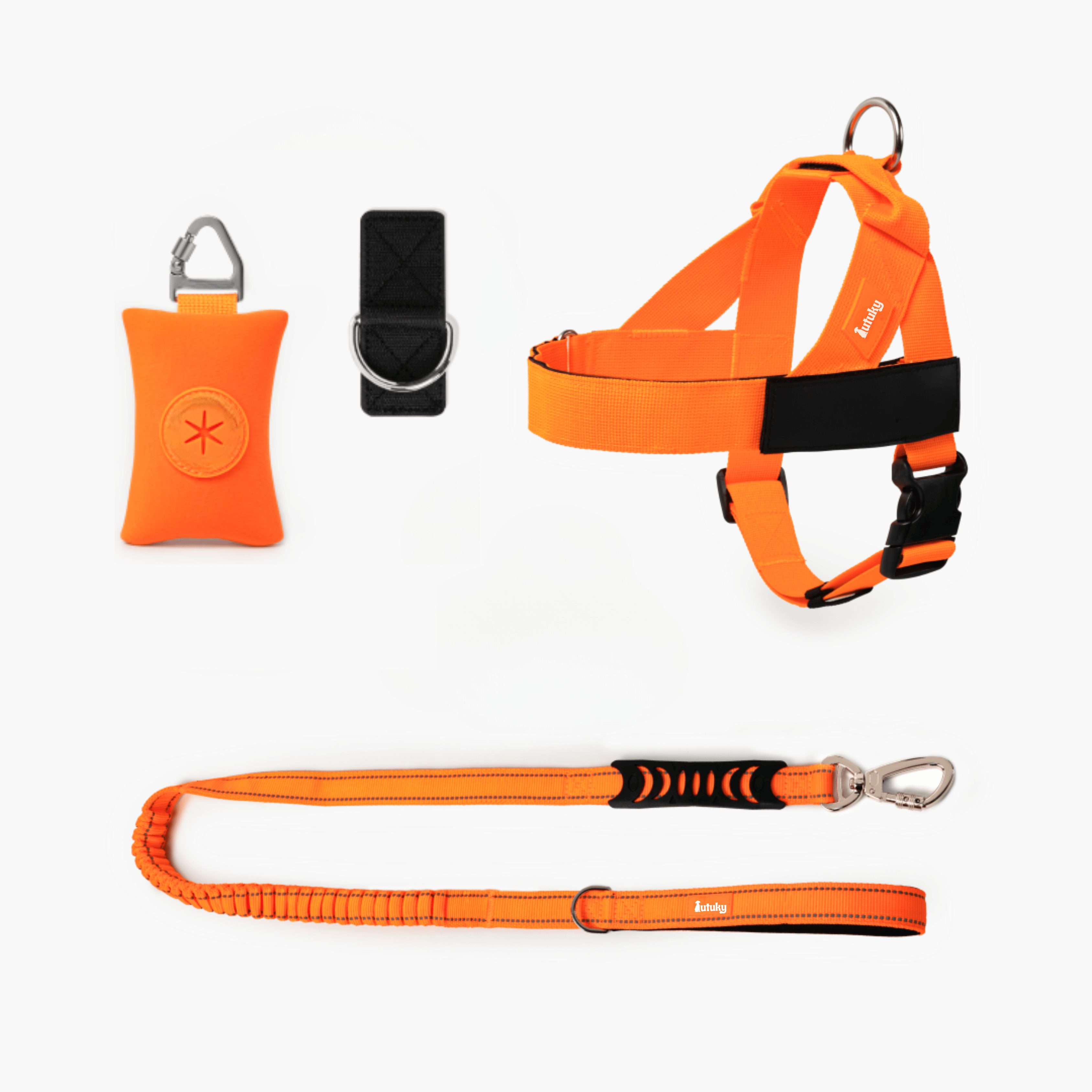 Orange dog harness, leash, and training clicker on a white background