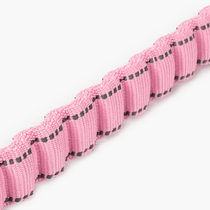 Pink and black camouflage patterned lanyard with a metal clip on a white background
