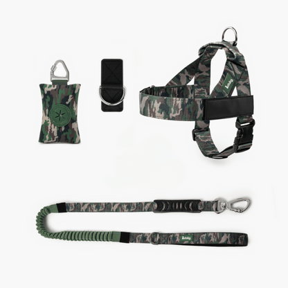 Camouflage dog harness, leash, and training clicker set on a white background